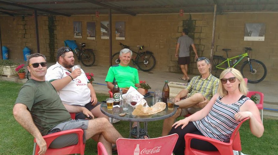 Friends gathered round a table with food and drinks