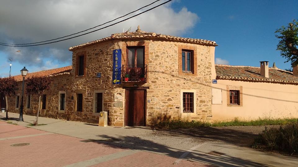 Old stone building with a sign that says Albergue