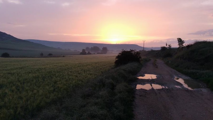 Photo of a sunrise, mountains and rural path