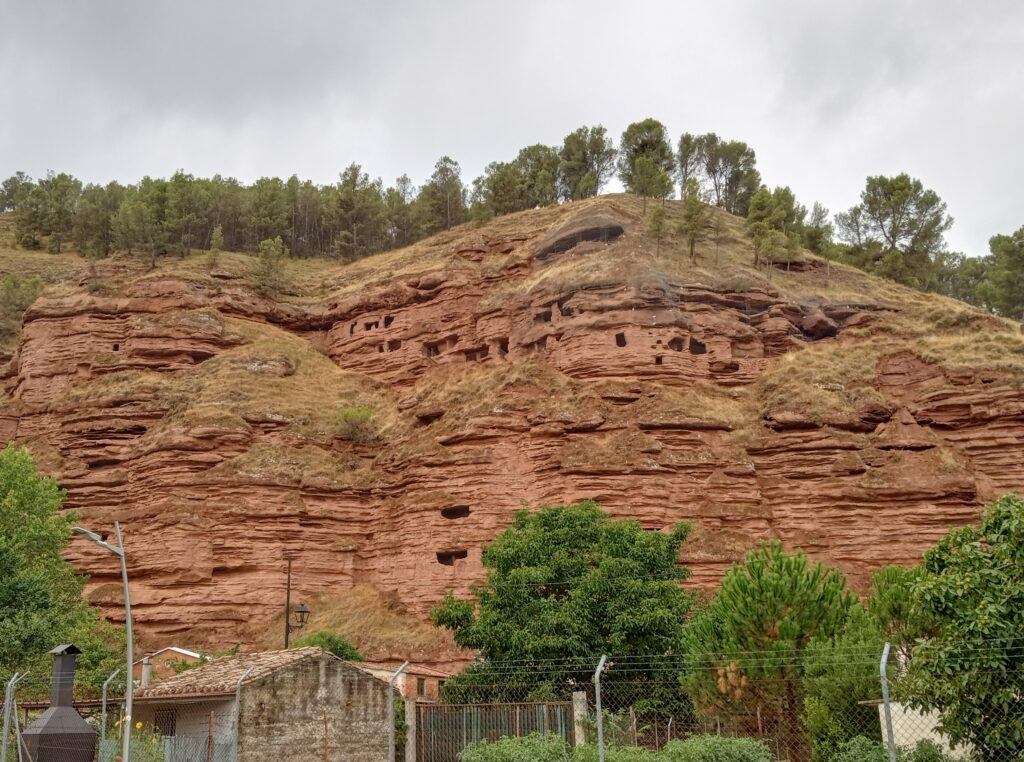 Red mountains with caves carved into the front